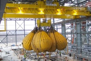 250/50 ton engineered crane undergoes load testing at a power plant. A specially engineered hoist features a service walkway to facilitate maintenance